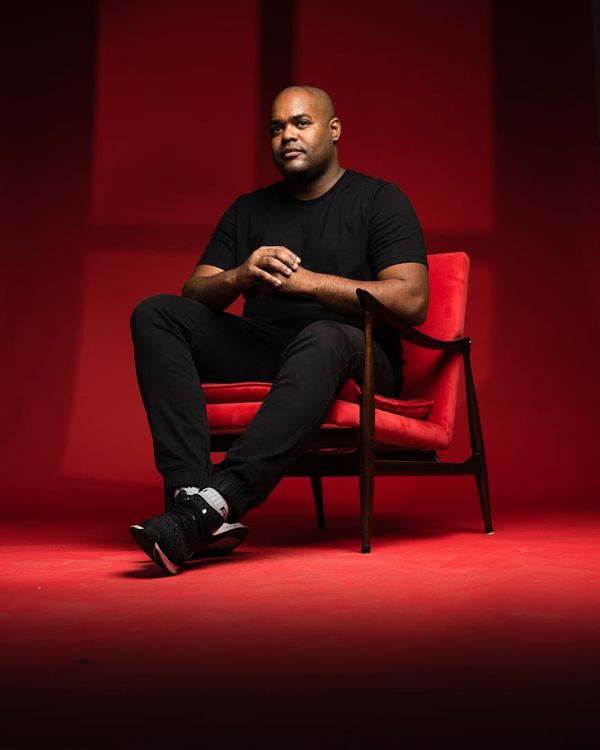 Silhouette of a man in a confident, strong posture against a light background.